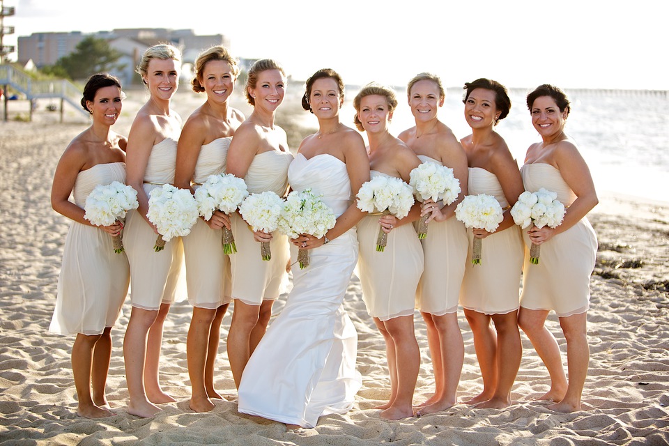 bridesmaids in nude dresses white flowers