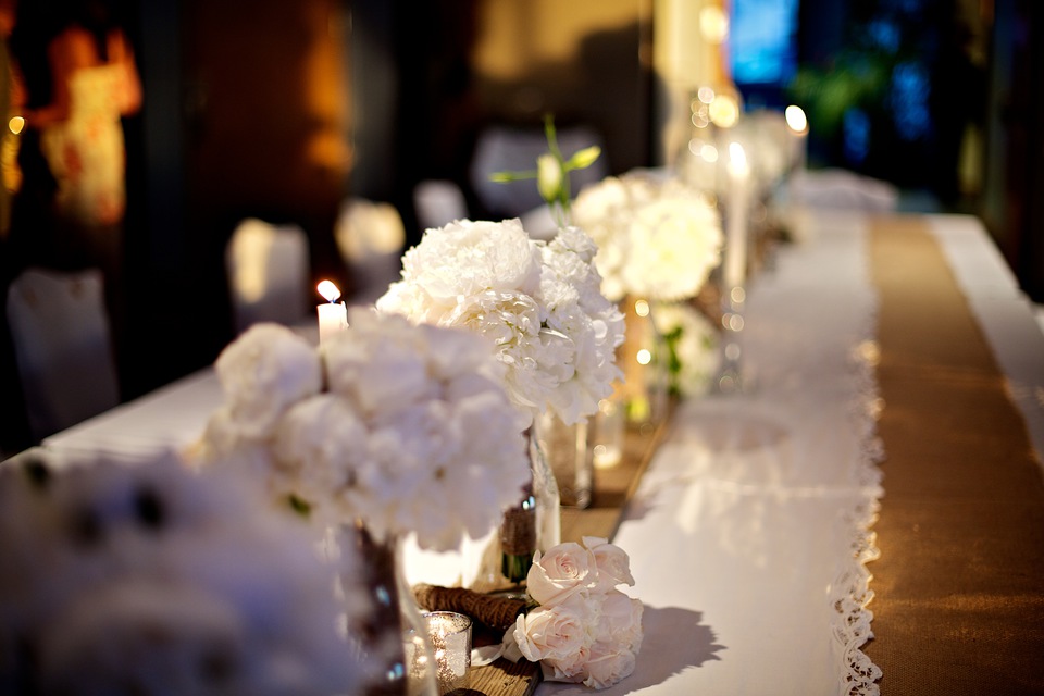 white flowers as table runner at wedding